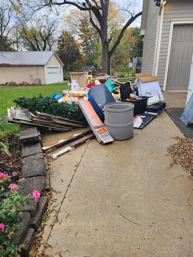 Dumpster being loaded with debris for 12 Yard Dumpster Rental in Lower Alsace